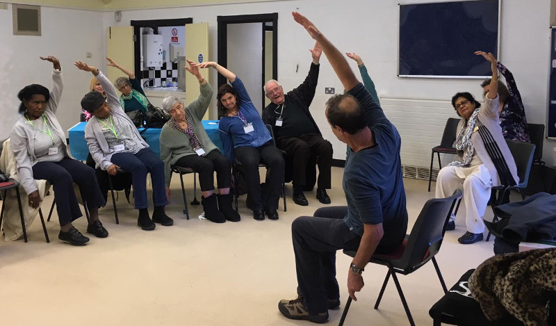 Richard leading the Dementia Club UK members through some gentle stretching exercises Richard leading the Dementia Club UK members through some gentle stretching exercises