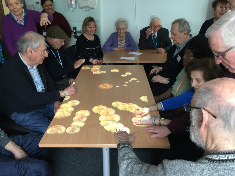 Members of Dementia Club UK enjoying the games on the Tovertafel (Magic Table) Members of Dementia Club UK enjoying the games on the Tovertafel (Magic Table)