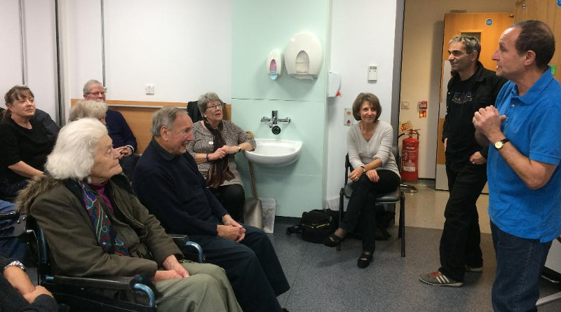 Chair exercises with Richard, watched by Andrea Hutter (sitting near the door). Chair exercises with Richard, watched by Andrea Hutter (sitting near the door).